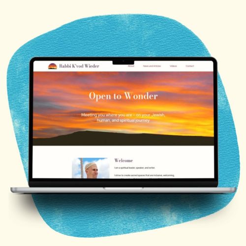 Laptop showing portfolio website against a background of blue watercolor